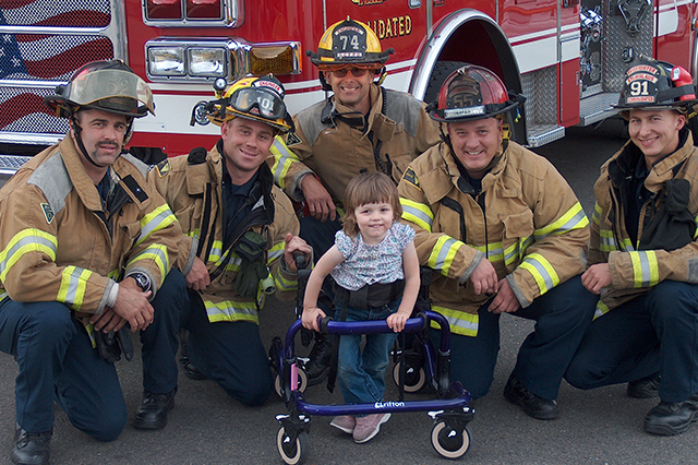 Firemen with little girl