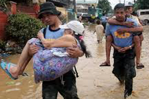 Good Samaritans carry children from flood